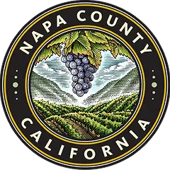 Seal of Napa County, California featuring a bunch of grapes hanging over vineyard rows with hills in the background.