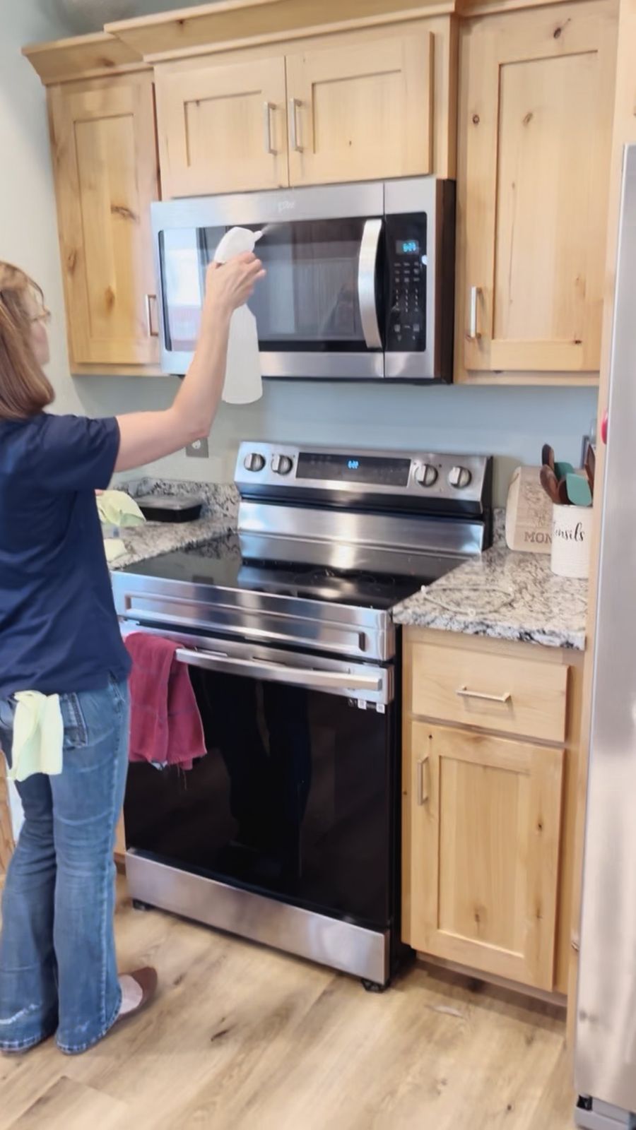 Cleaning the front of a microwave in a client's kitchen