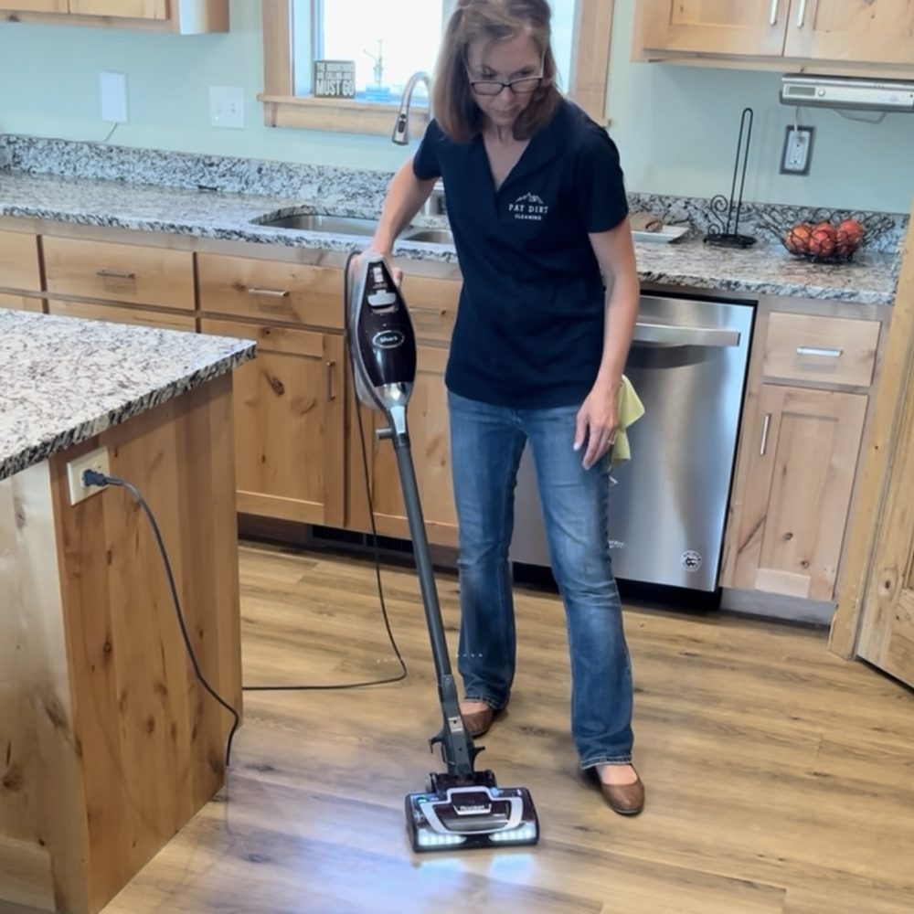 Vacuuming a kitchen floor