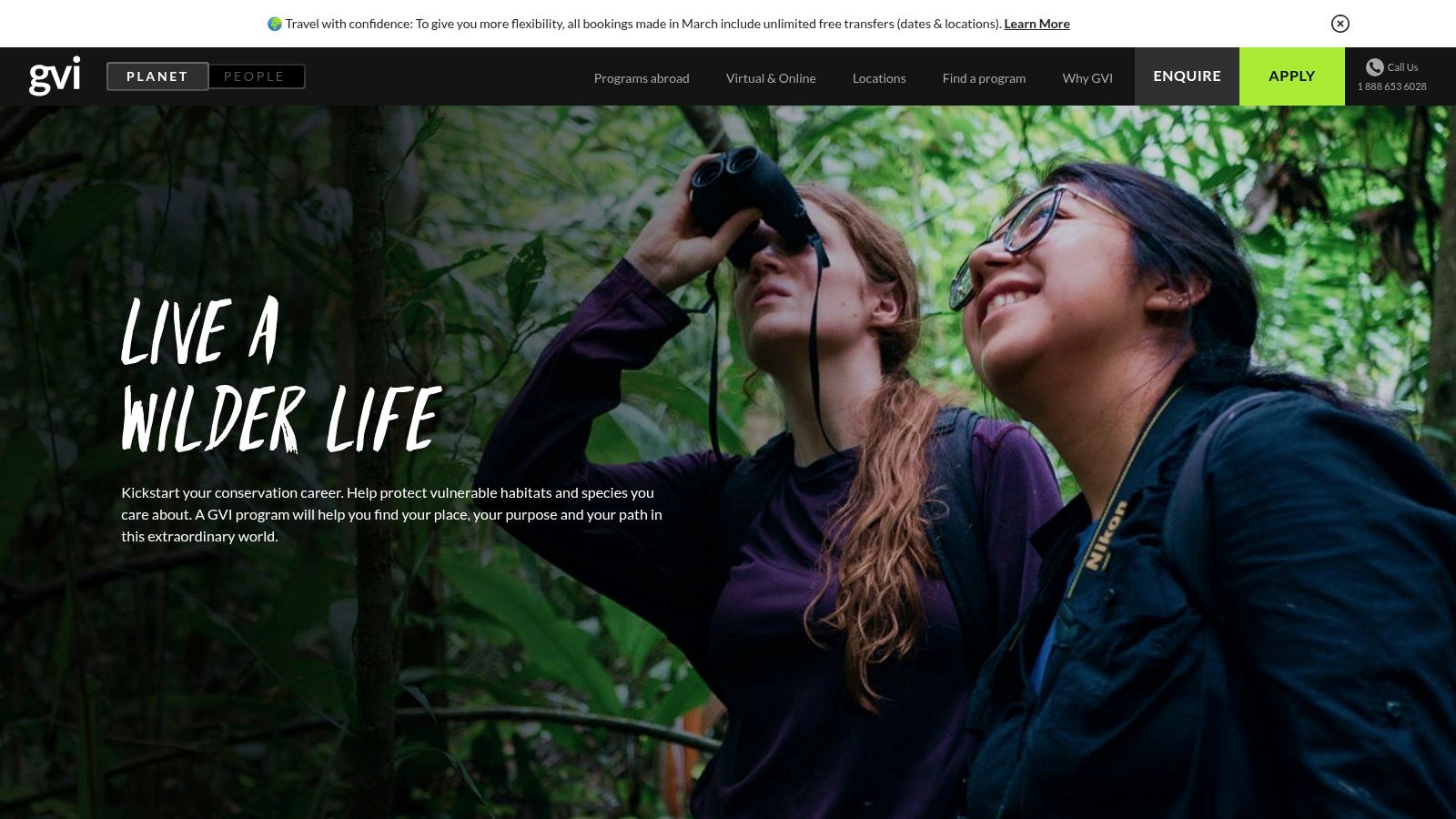 A volunteer observing wildlife in a lush, green natural habitat.