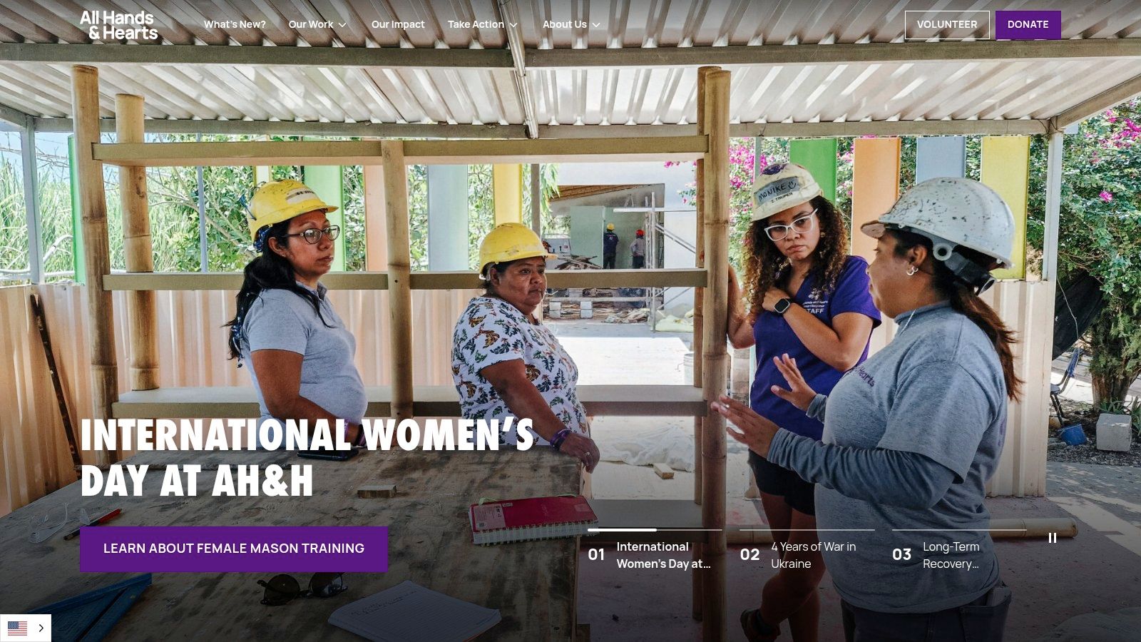 Female volunteer masons working on a wall with All Hands and Hearts.