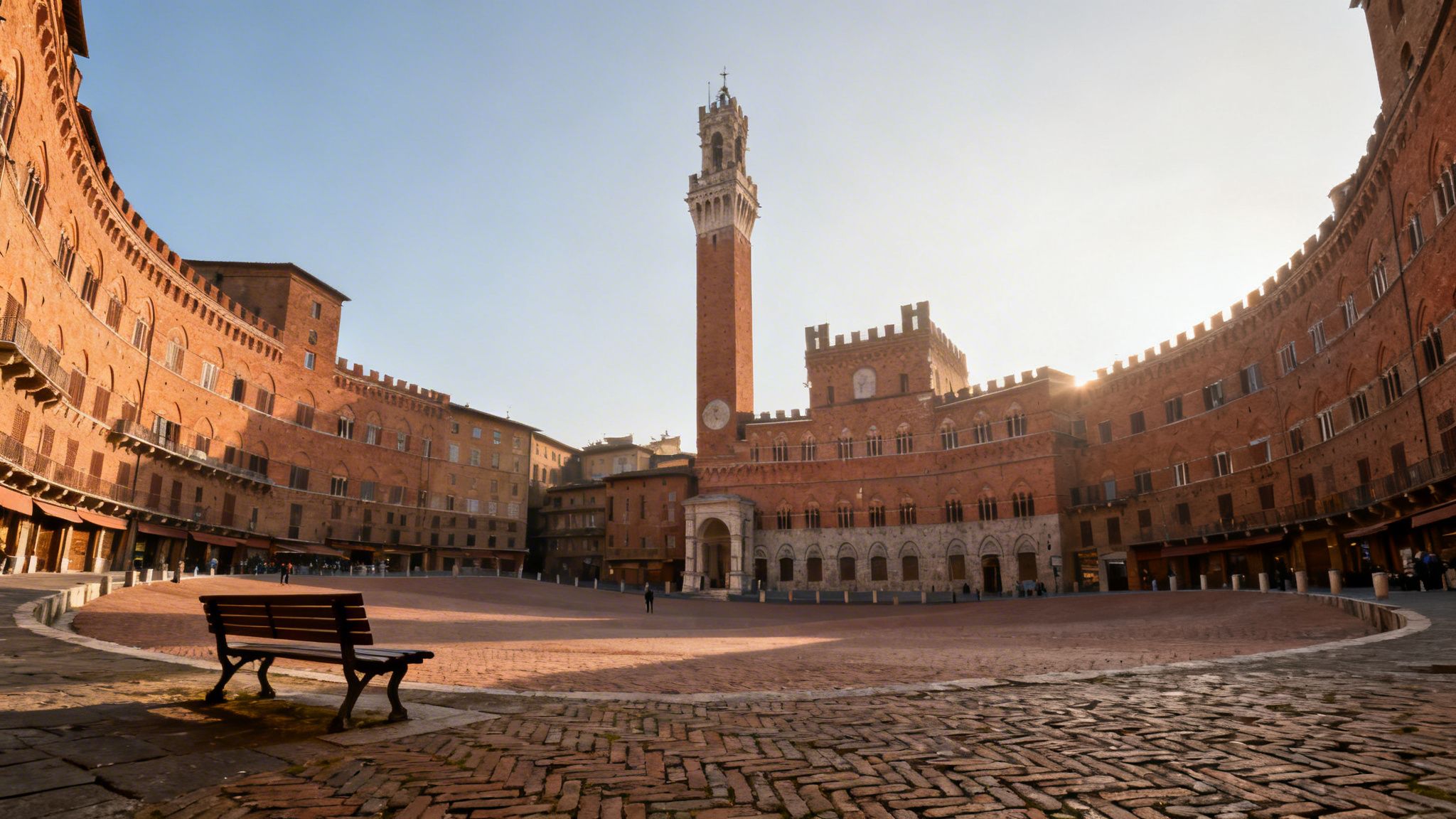 Wide angle view of the historic Piazza del Campo in Siena, Italy, featuring the Torre del Mangia tower.