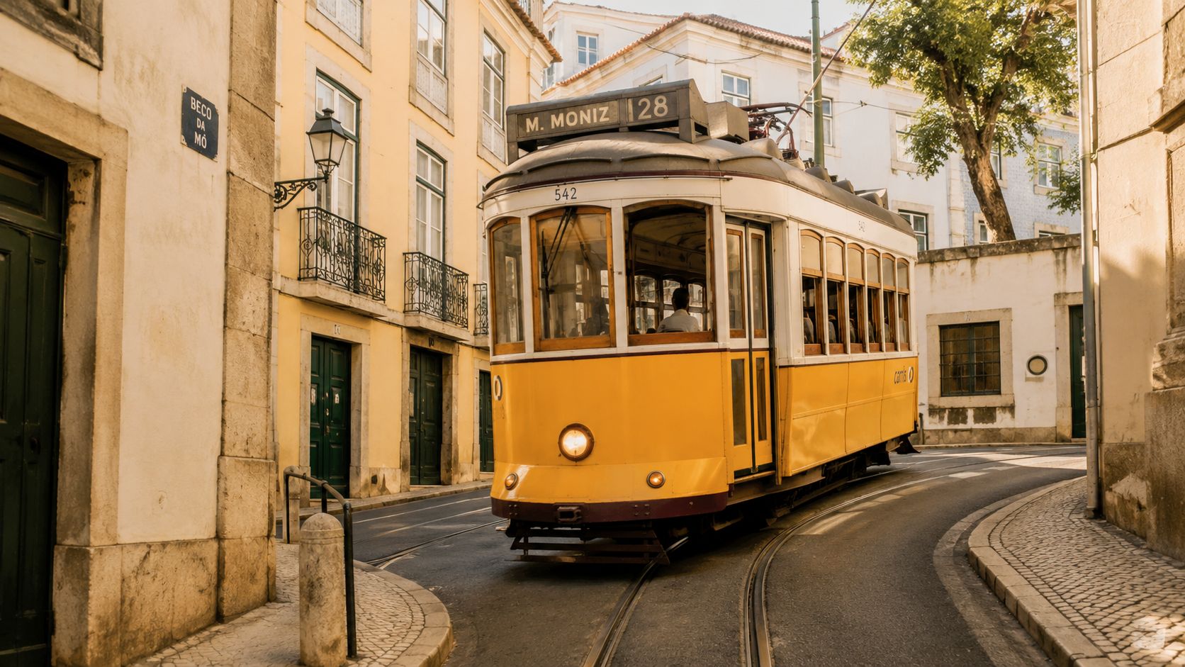A classic yellow tram travels along the narrow cobblestone streets of Lisbon, Portugal on a sunny day.