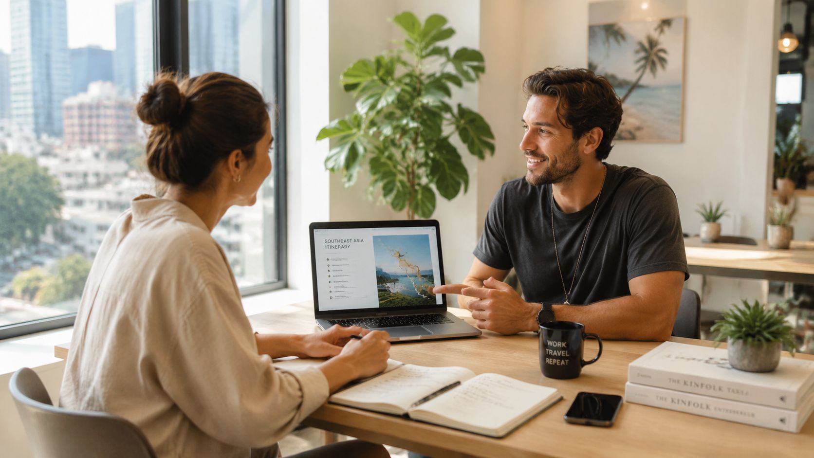 A professional man and woman discussing a travel itinerary on a laptop in a bright modern office.