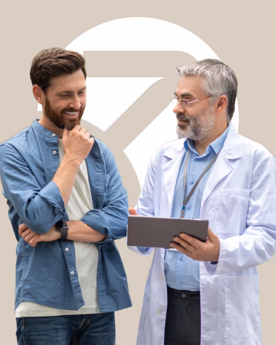 Urologist in a white coat reviewing results on a digital tablet with a male patient.