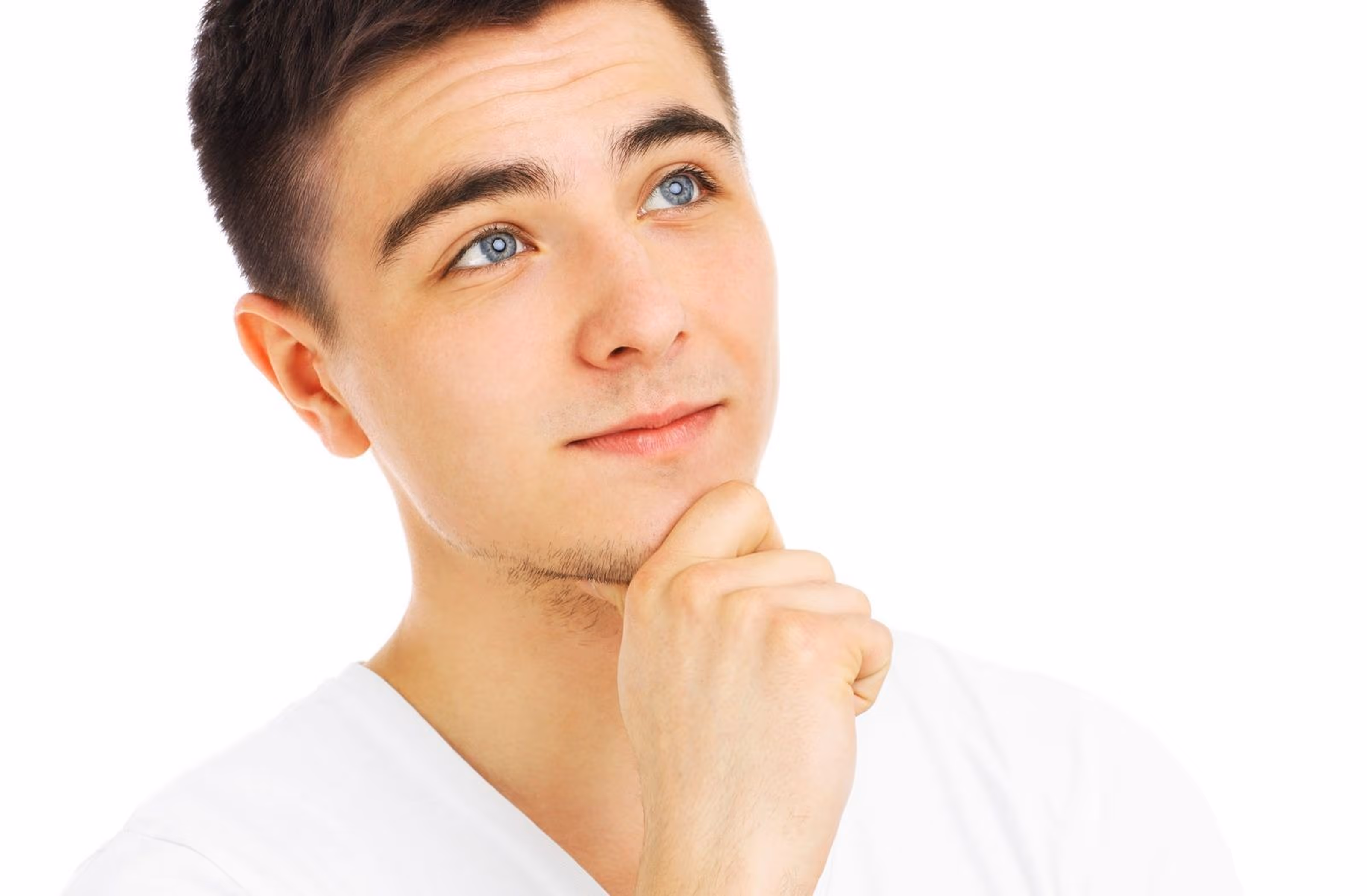 Close-up portrait of a young man looking upward with a thoughtful expression.