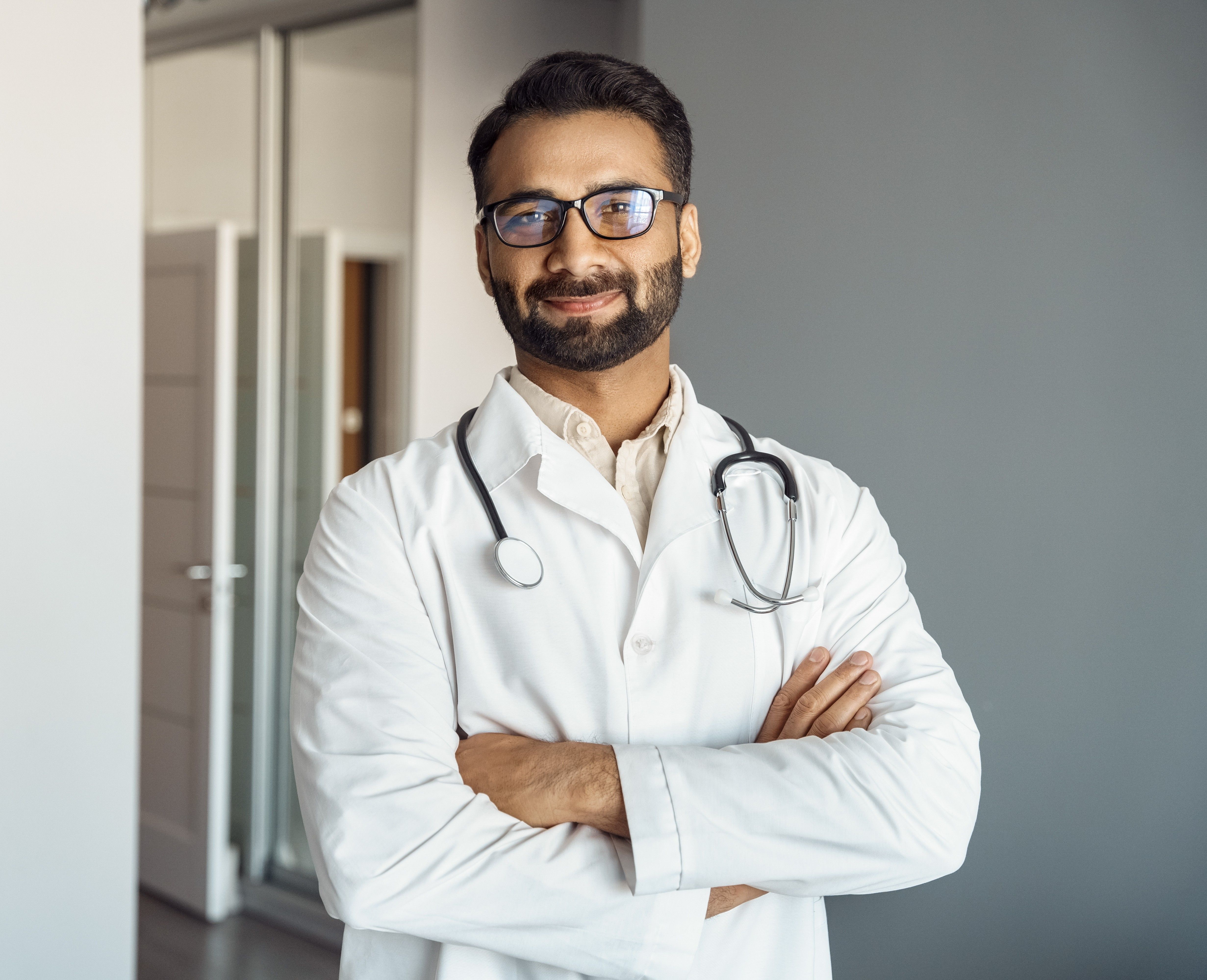 Male Urologist smiling with arms crossed 