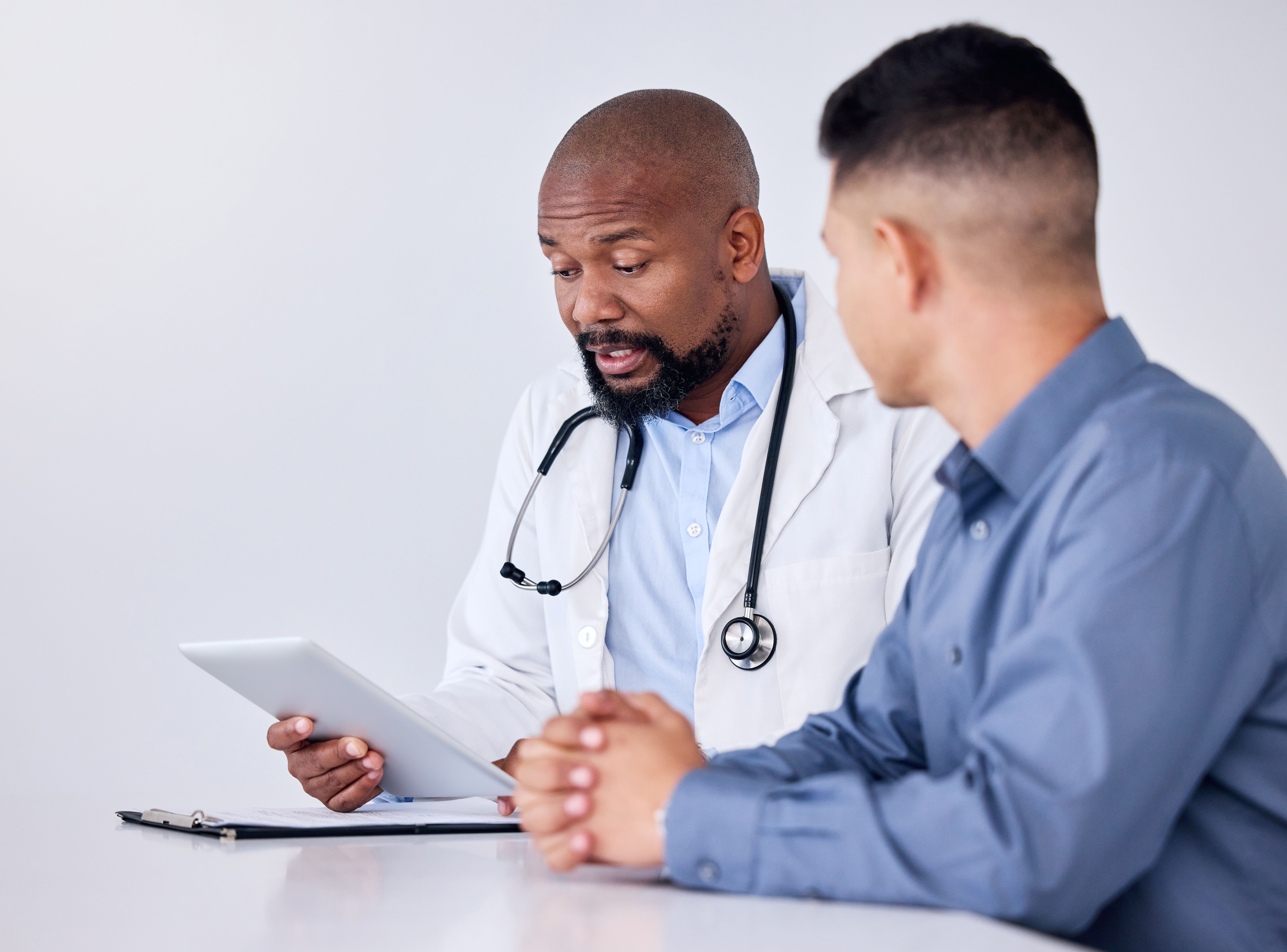 Urologist in office discussing results with male patient