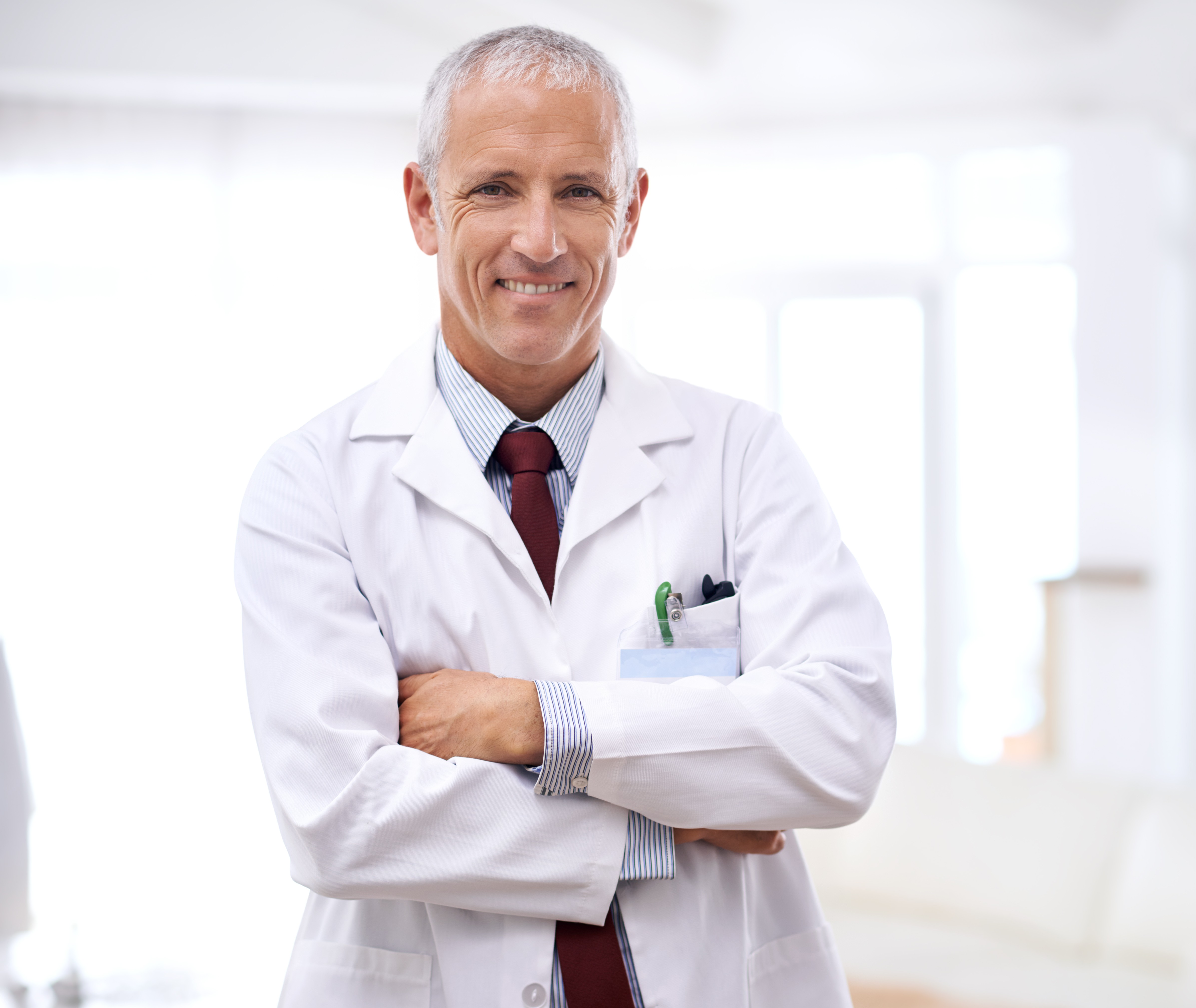 Male Doctor smiling with arms crossed