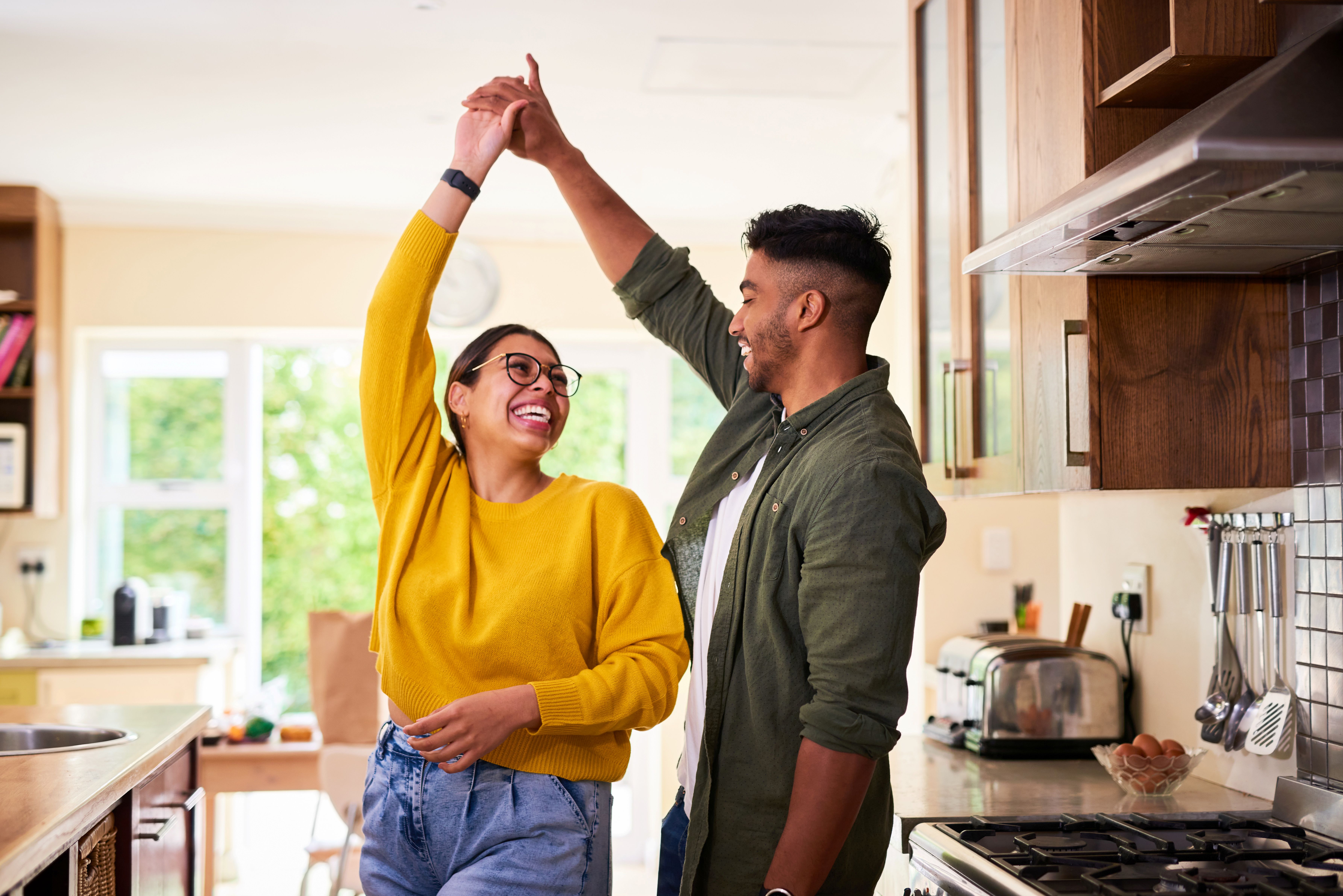 Male and Female couple dancing in the kitchen