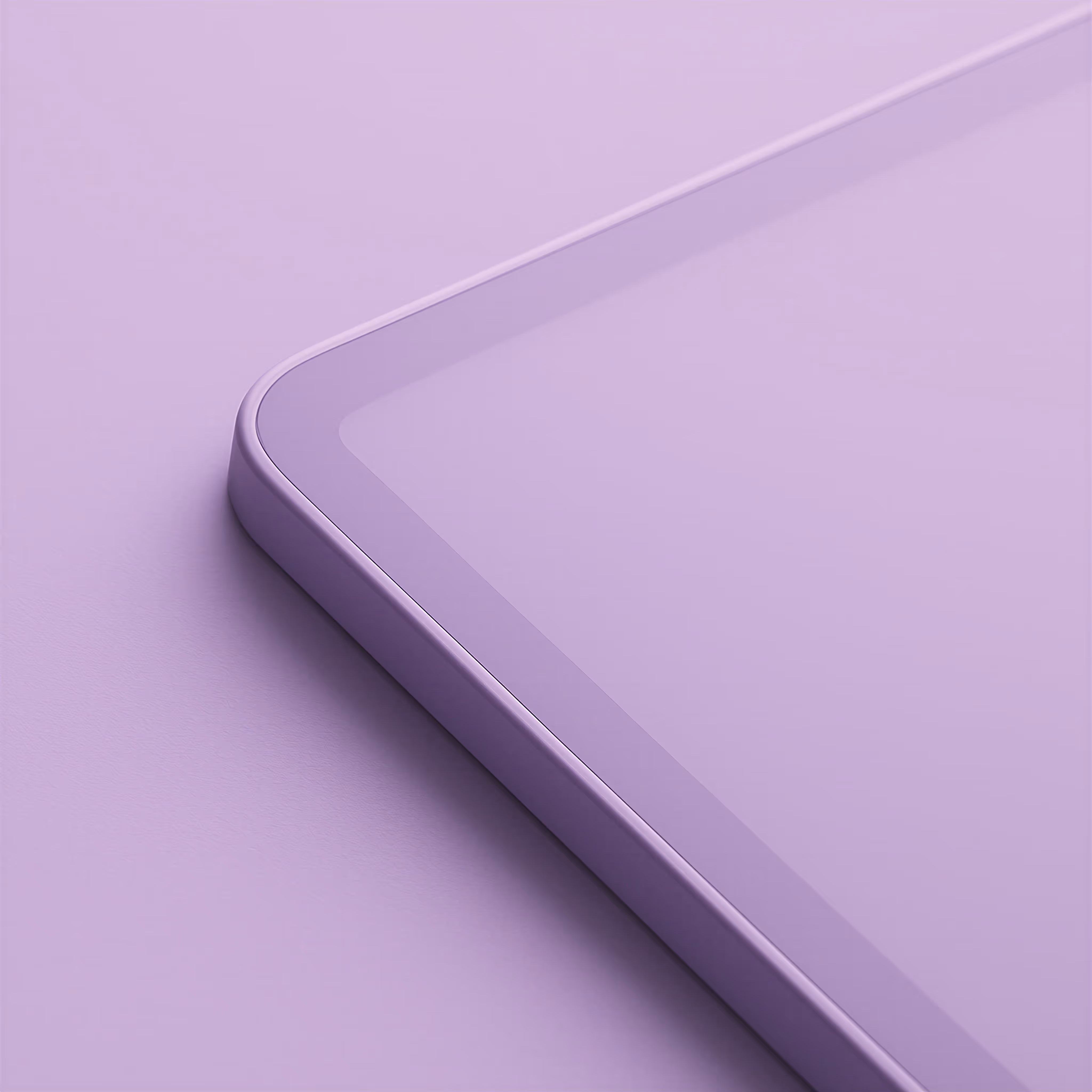 Close-up of a corner of a tablet with a smooth glass screen and rounded edges on a purple surface.