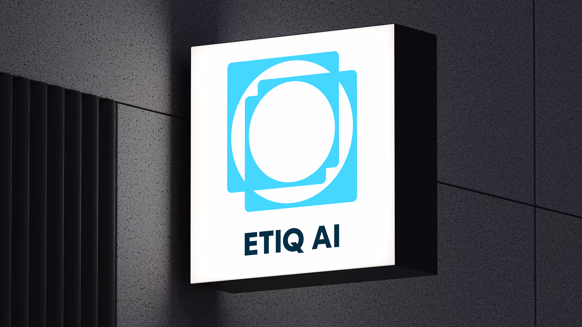 Empty auditorium with rows of chairs facing a large screen displaying ETIQ AI logo and text 'Real-time testing as you code'.