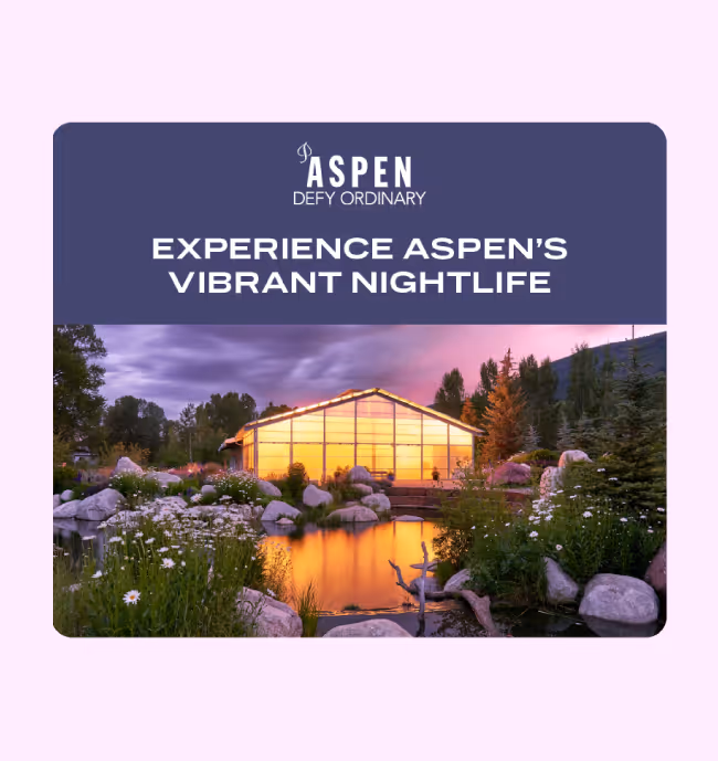 Display ad which includes a scenic view of a modern glass building illuminated at sunset, reflected in a pond surrounded by rocks, flowers, and trees.