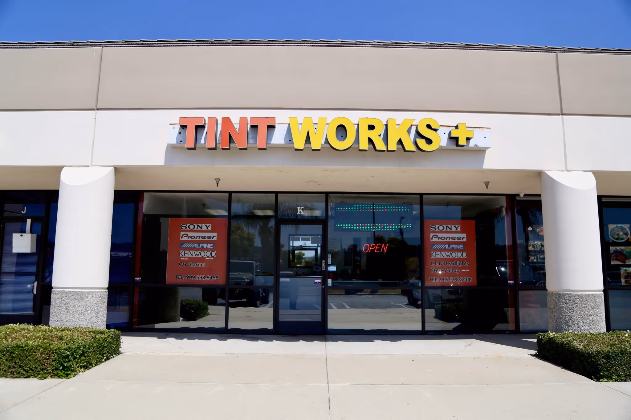 Storefront of Tint Works+showing the glass door entry.