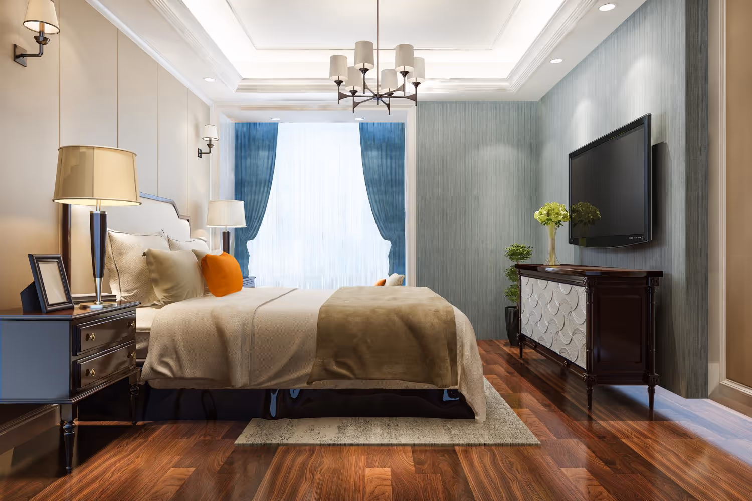Modern bedroom with a large bed, beige bedding, orange accent pillows, wooden floor, bedside tables with lamps, blue curtains, and a wall-mounted TV.