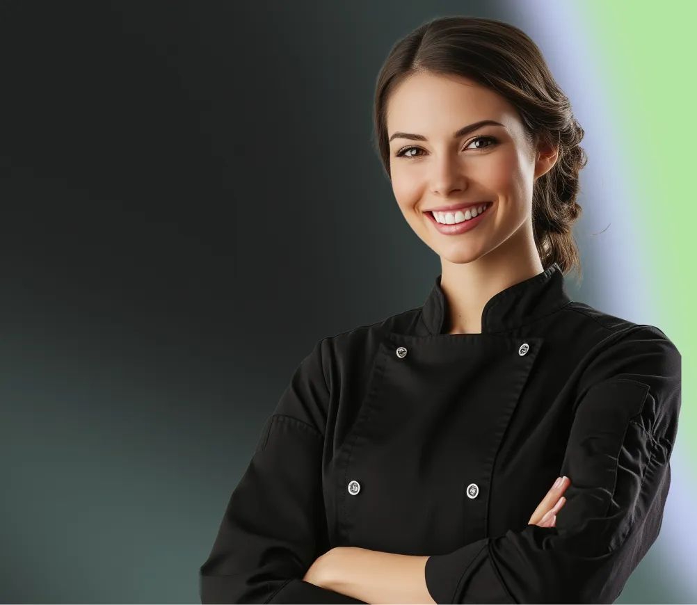 Smiling female chef in a black uniform with folded arms, standing against a dark teal gradient background.