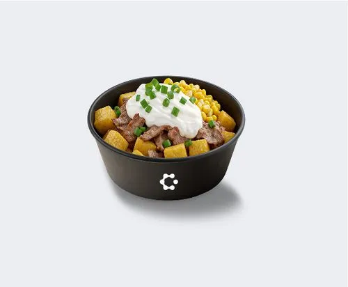 A black bowl with green soup topped with croutons and herbs, featuring a white Circus icon on the front.