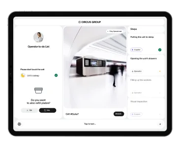 A tablet displaying the CIRCUS OS dashboard interface for managing CA-1 robotic kitchen operations, including sleep mode, refill options, and task status.