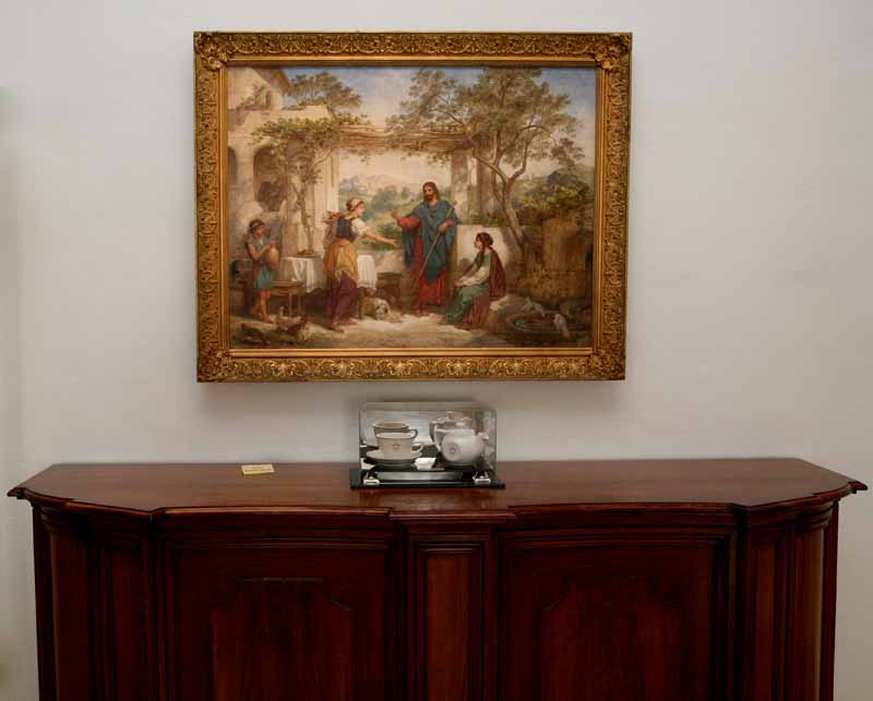 Framed painting 'The Promised Land' by Heinrich Hofmann, depicting a man standing with a staff and two women in a garden setting, one holding a jug.