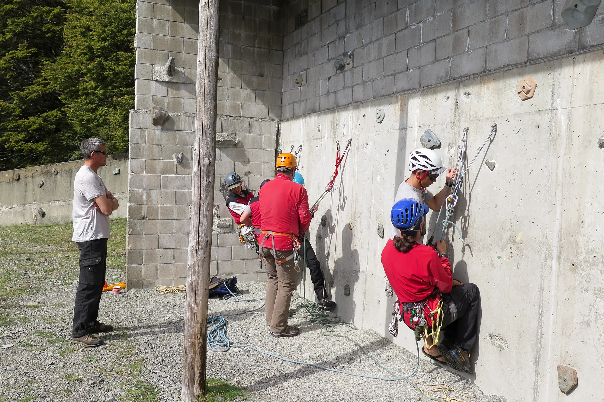 Climbers practicing basic techniques on the indoor wall at the Alpine Guides base.
