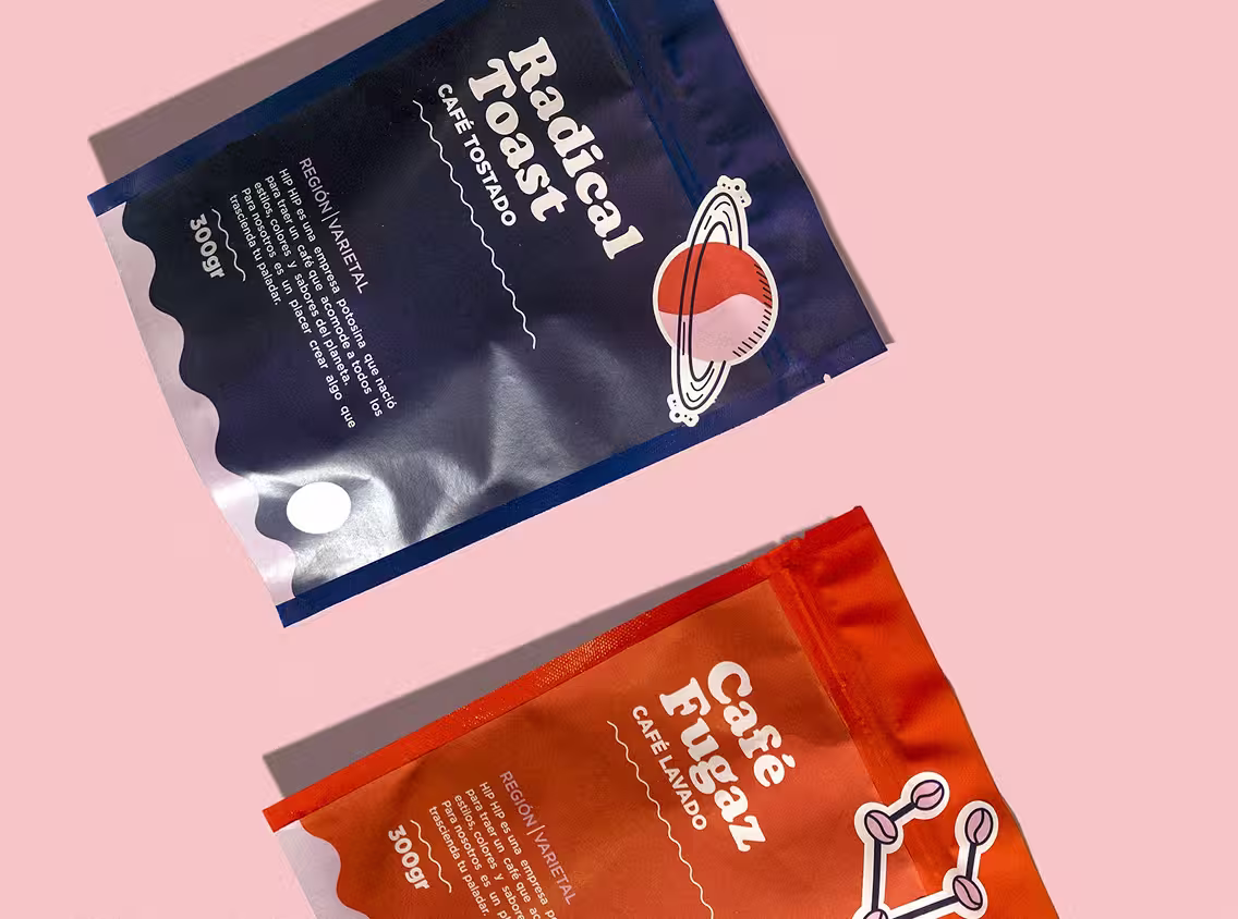 Flatlay composition featuring stationery and orange product packaging on a pastel background.