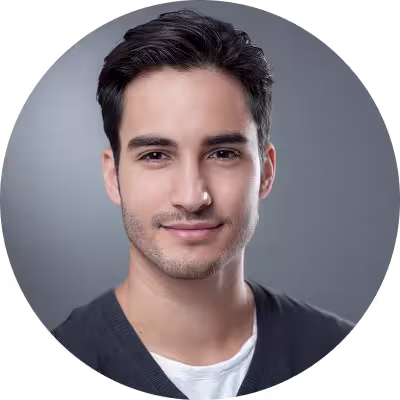 Circular portrait avatar of a smiling man on a neutral background.