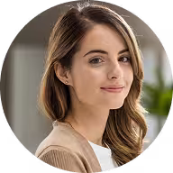 Circular portrait avatar of a smiling woman in a bright indoor setting.