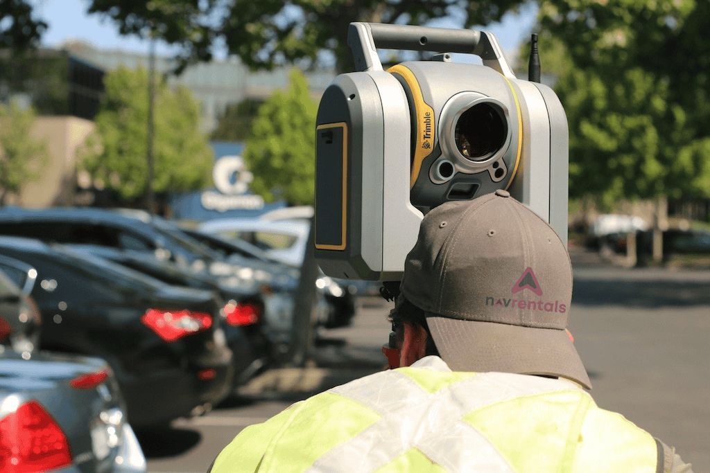 Operator using survey equipment illustrating civil and project site services