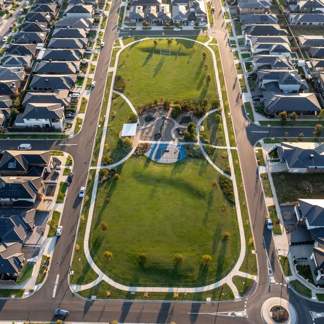 Aerial view of a park with roads and houses surrounding it