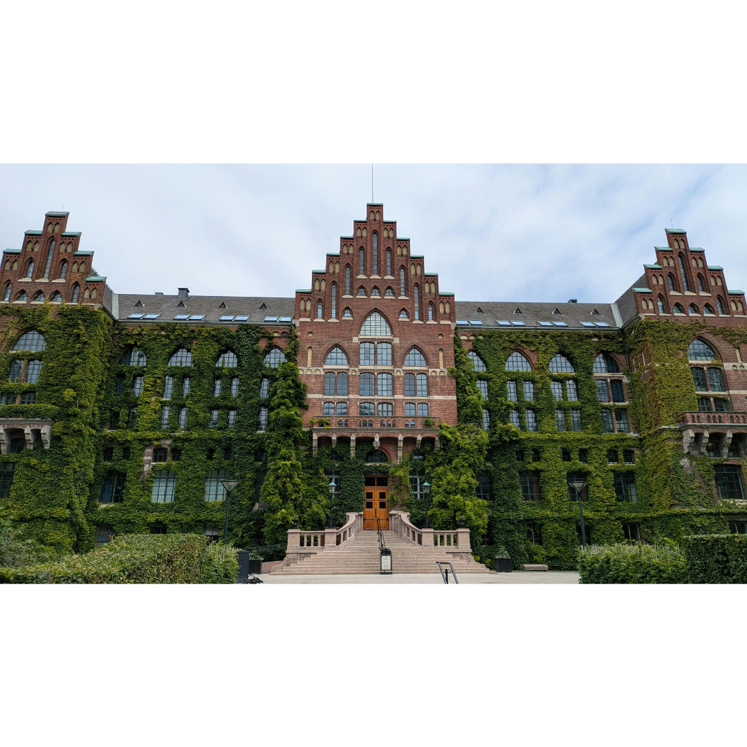 A brick university building covered in ivy.