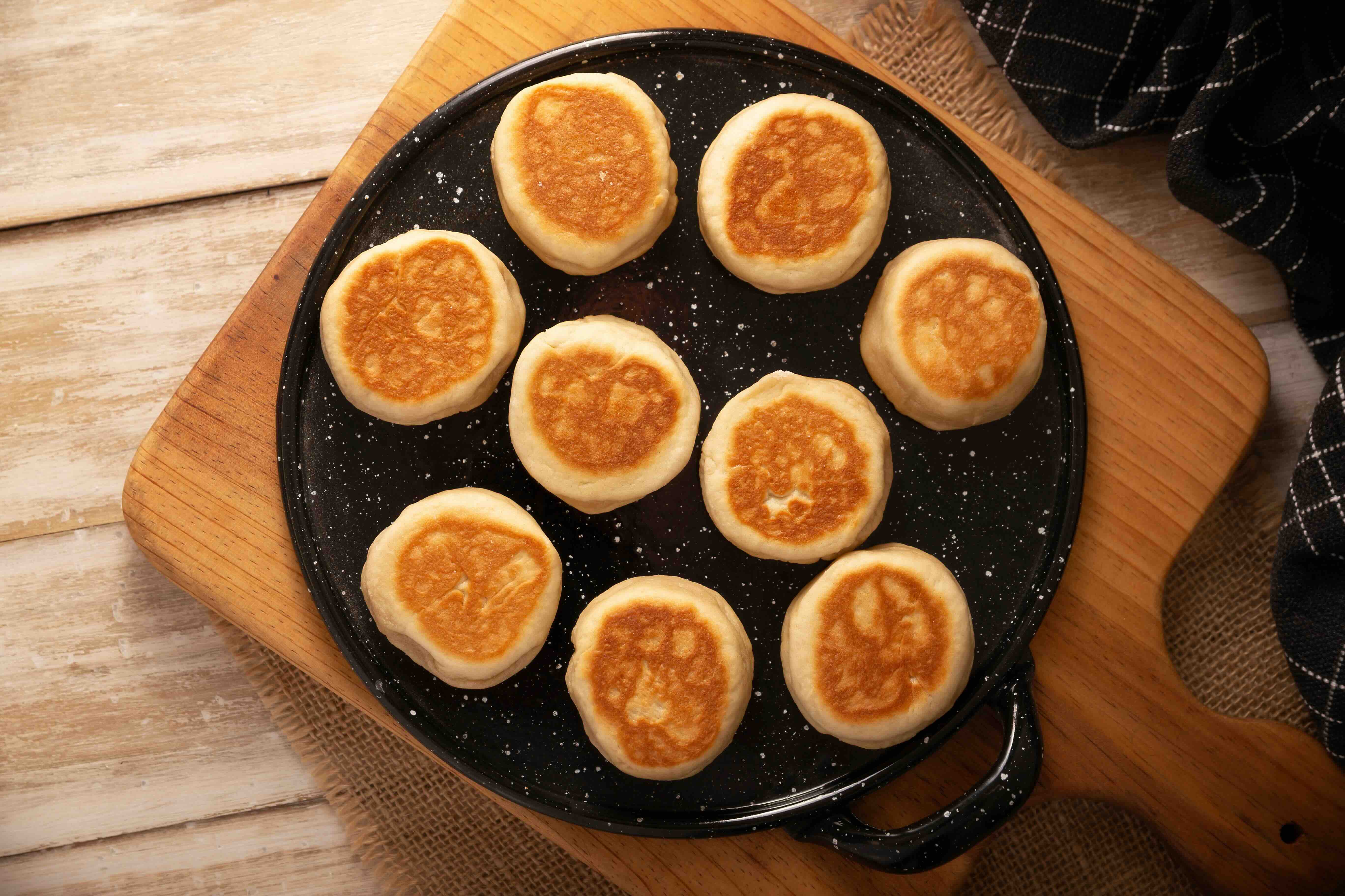 Gorditas de nata (cream gorditas) resting on an enamel-coated comal.