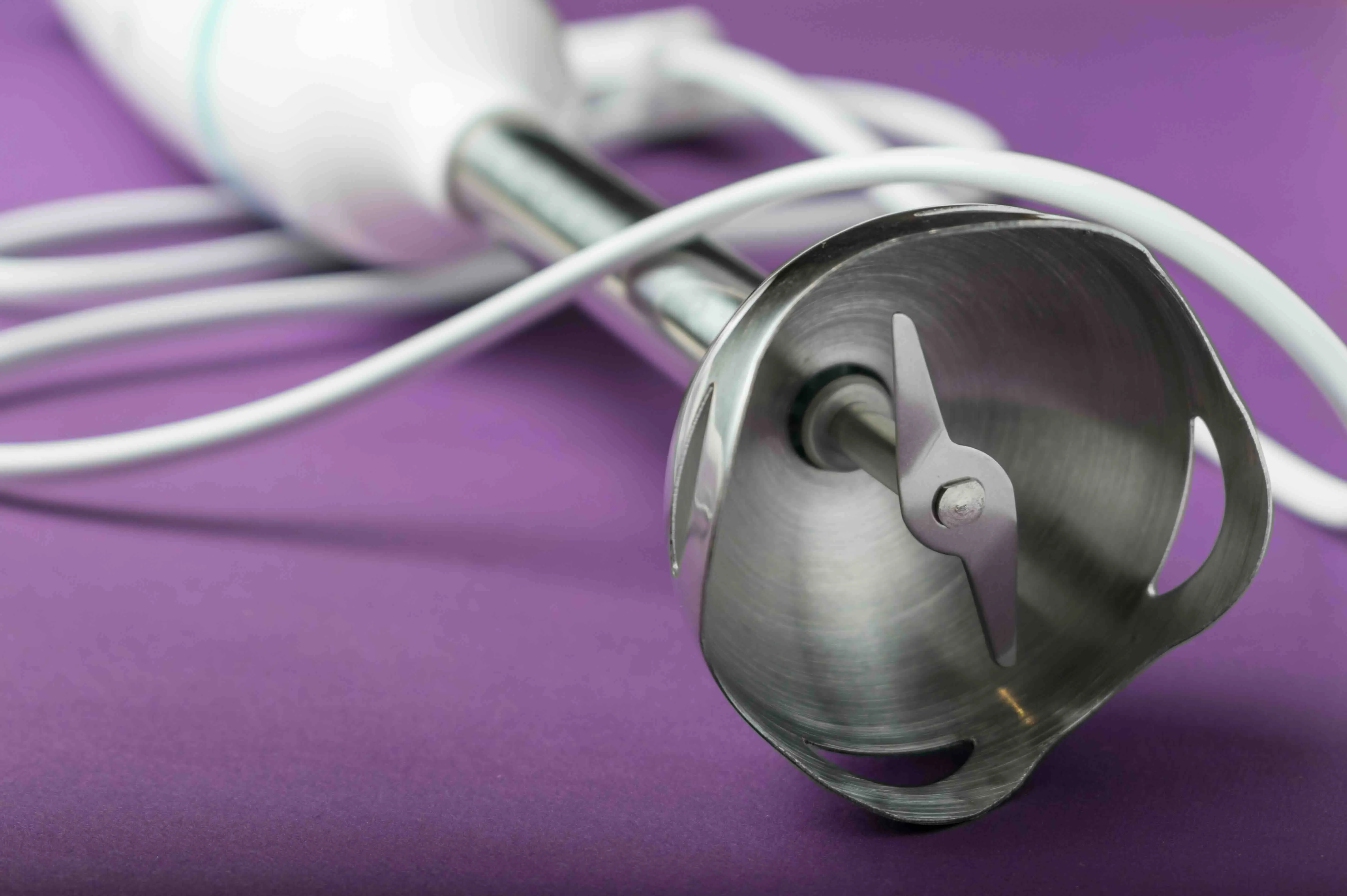 Close-up of a metal immersion blender.