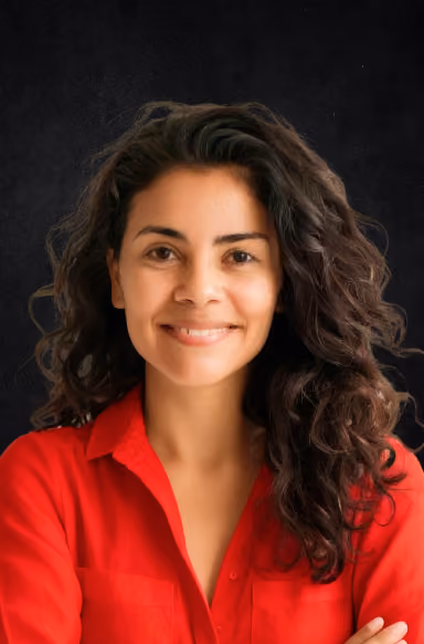 Person with curly hair in red shirt