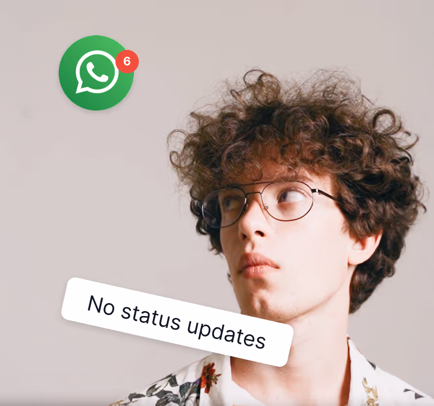 Young man with curly hair and glasses looking up, with WhatsApp icon showing 6 unread notifications and text 'No status updates'.