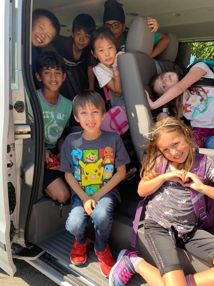Campers smiling in the AMAA van