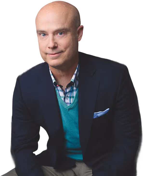 Portrait of Ben Morley wearing a blue blazer, teal sweater, and checkered shirt with a slight smile.