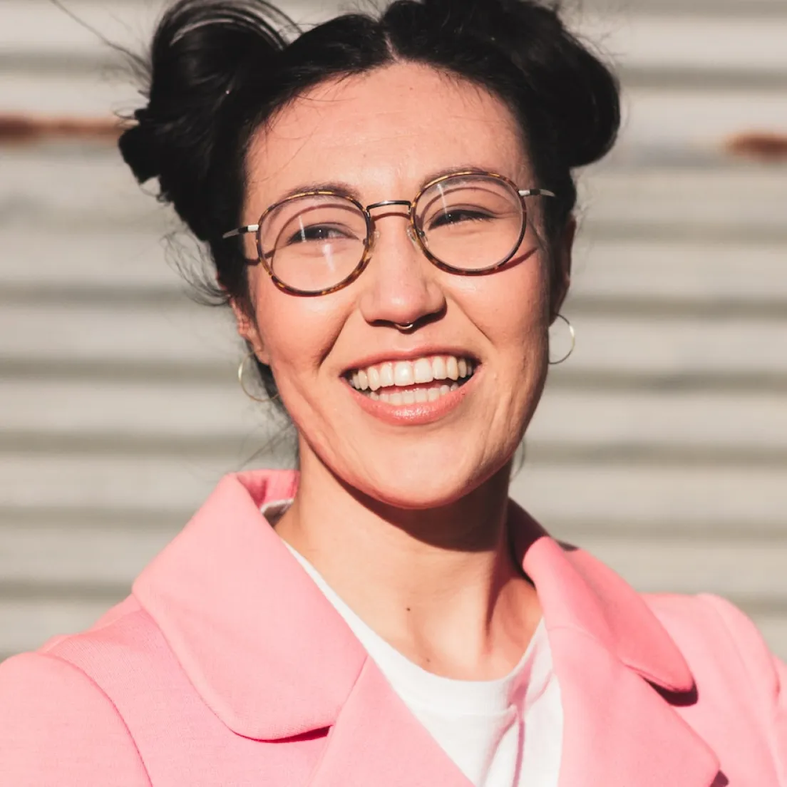 a woman wearing glasses and a pink jacket - volunteer - best organization website webflow CMS template