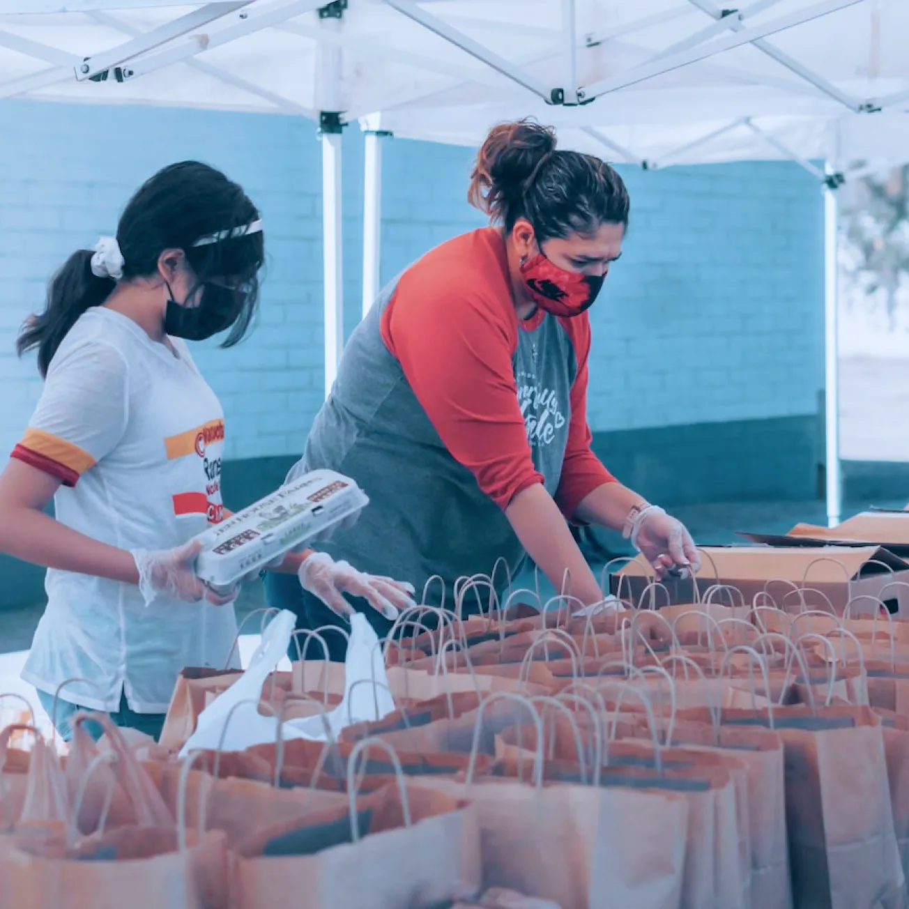 a couple of women standing next to each other - volunteer - best organization website webflow CMS template