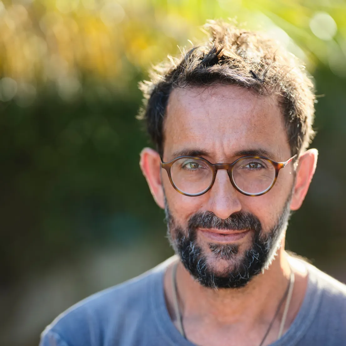 a man with a beard and glasses is smiling - volunteer - best organization website webflow CMS template