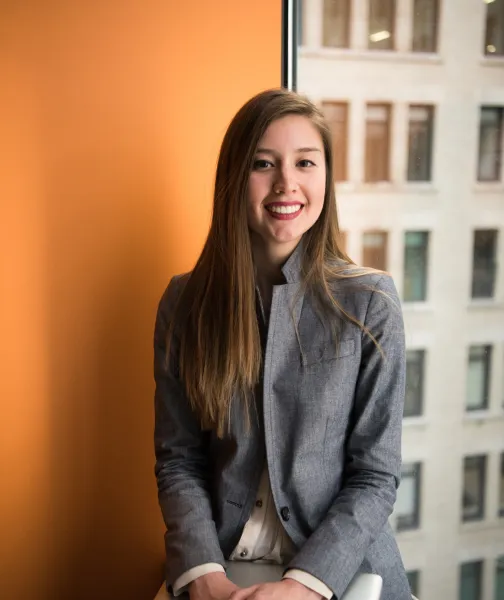 a woman sitting in a chair in front of a window - volunteer - best organization website webflow CMS template