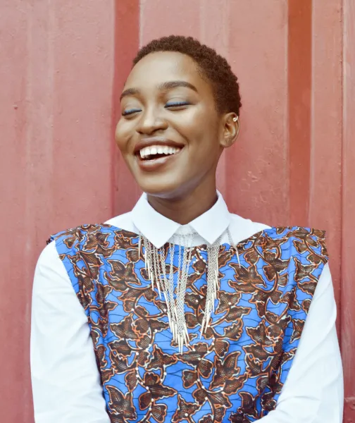 a woman smiling and wearing a blue and brown dress - volunteer - best organization website webflow CMS template