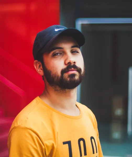 a man with a beard wearing a yellow shirt - volunteer - best organization website webflow CMS template