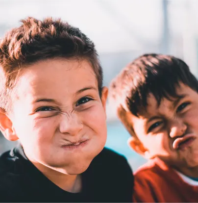 a couple of young boys standing next to each other - volunteer - best organization website webflow CMS template