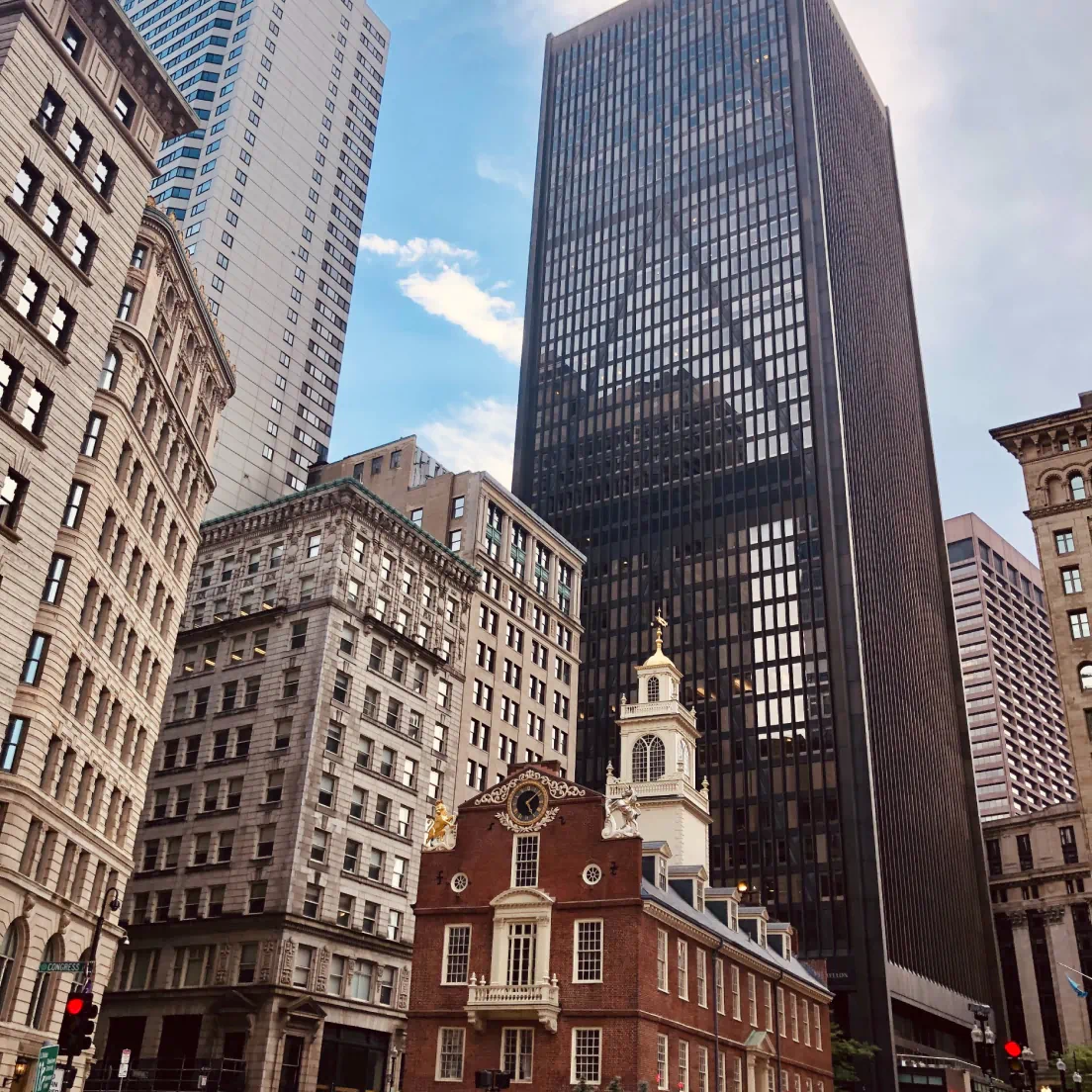 a city street with tall buildings and a clock tower - volunteer - best organization website webflow CMS template