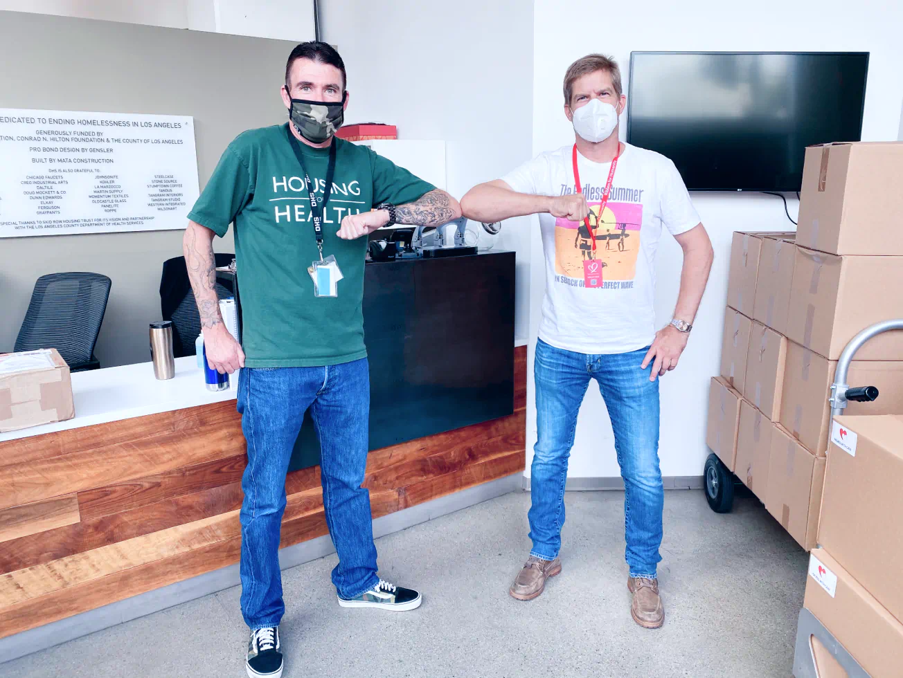 a couple of men standing next to each other in a room - volunteer - best organization website webflow CMS template