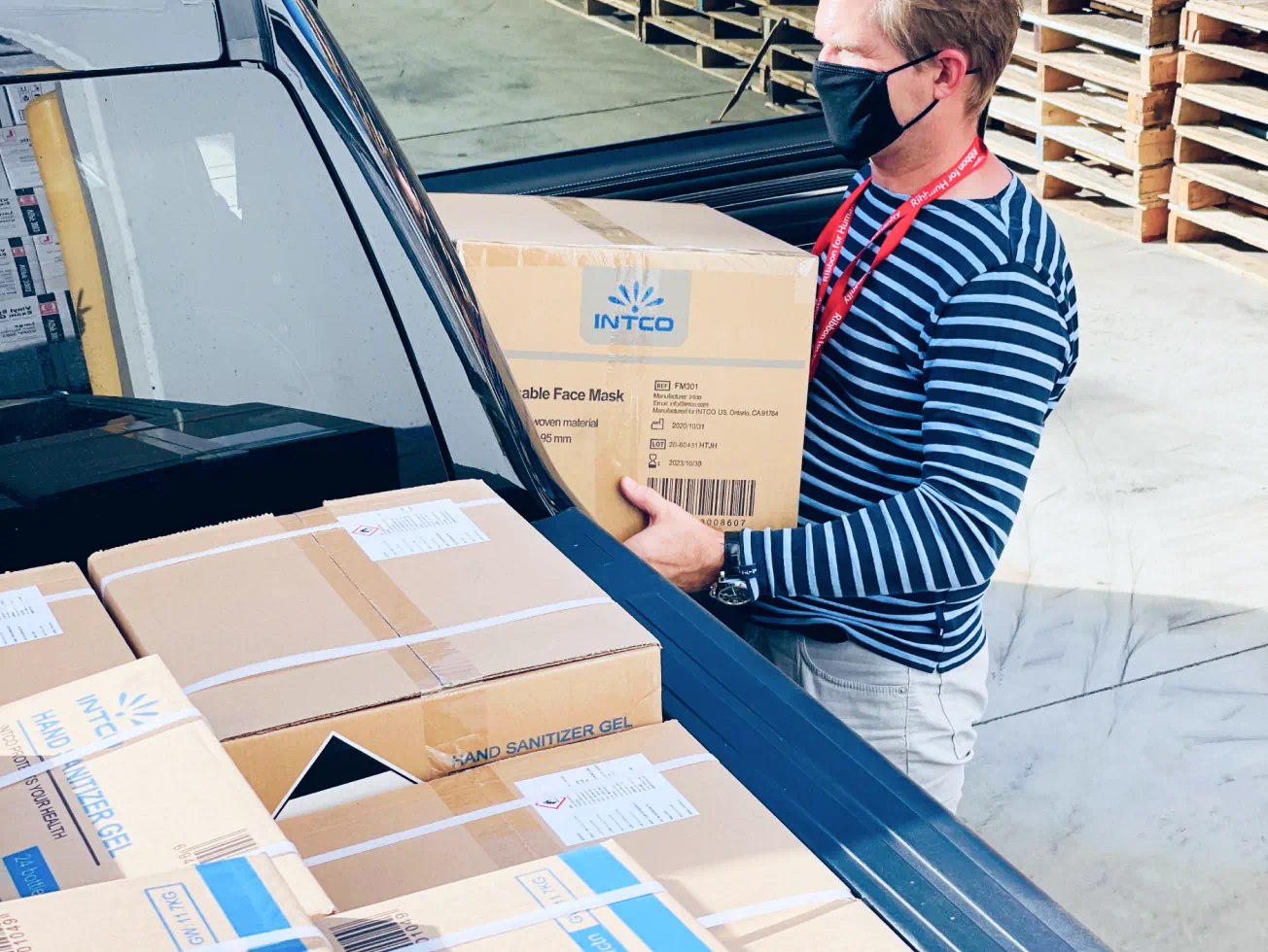 a man in a face mask unloading boxes from the back of a truck - volunteer - best organization website webflow CMS template