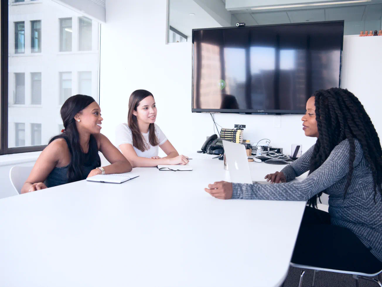 a group of women sitting around a white table - volunteer - best organization website webflow CMS template