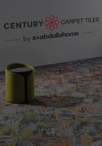Modern carpet tiles with abstract pattern and a green fabric stool on the floor.