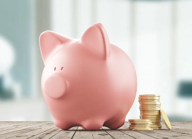 piggy bank with coins next to it