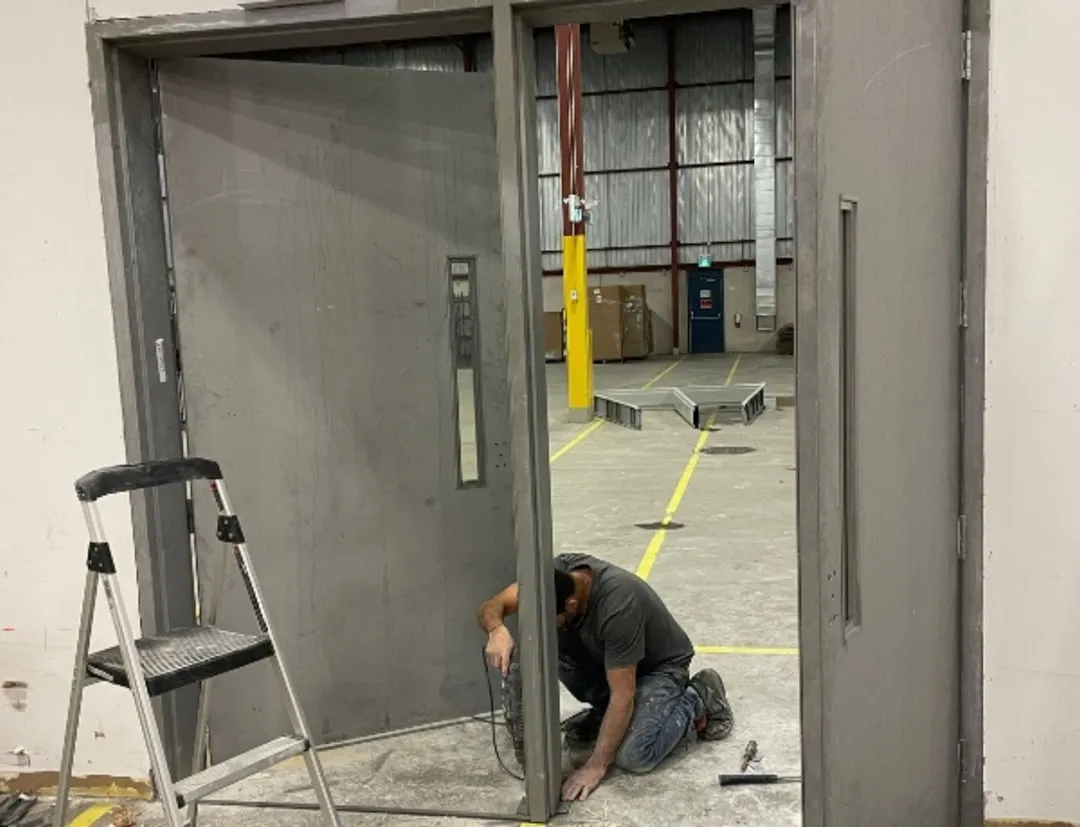 technician performing safety check commercial garage door - commercial garage door installation austin